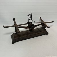 Full view of cast iron balance scale on white background