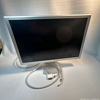 Front view of Apple Cinema HD Display with attached cable