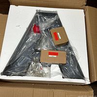 Letter A light fixture in styrofoam packaging inside box
