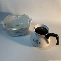 casserole with glass lid and coffee percolator pot side by side