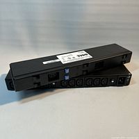 Two Dell AP6020 PDUs stacked showing outlet side and input end