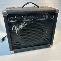 Front view showing Fender logo, grille, control panel knobs, handle, overall wear