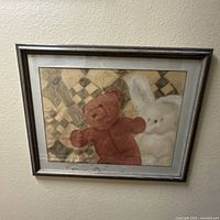 Framed print showing entire artwork with teddy bear and rabbit, silver frame visible