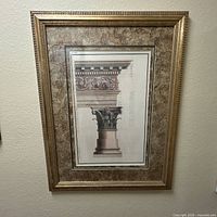 Full view of framed architectural print showing image, mat, and gold frame