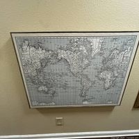 Front view of large framed monochrome world map wall art