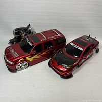 Two RC cars, transmitter visible