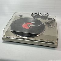 Full view of Pioneer PL-200 turntable with dust cover closed, RCA and power cables visible