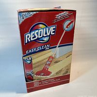 Front of opened, damaged box showing Resolve Easy Clean Pro gadget and foam refill