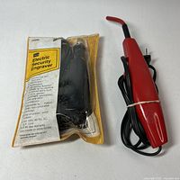 Engraver with cord, packaged manual and tip visible