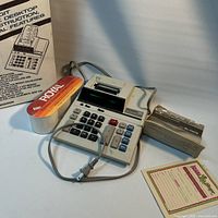 All lot contents: Sharp EL-1197S calculator, power cord, Royal paper rolls pack, original box, manual