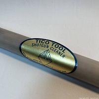 Close view of brass Tico Tool Shotgun Cleaner label on gray tube