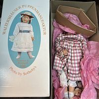 Box lid with brand name and doll image