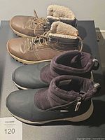 Both pairs of boots side by side on table