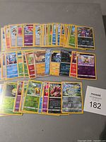 All 49 Pokémon holo and reverse holo cards spread on tabletop