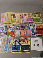 Overall view of all 50 Pokémon holo and reverse holo cards spread on table