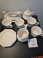 Overall view of porcelain coffee/tea service pieces on table