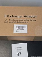 Sealed cardboard box labeled EV charger Adapter