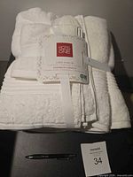 Bundled white towel set with tag and ribbon