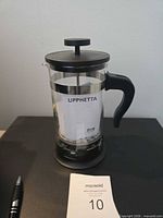 Front view of IKEA Upphetta French press showing label and handle