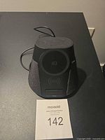 Front view showing Qi charging pad, speaker grille, display