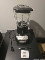 Full blender showing jar, lid, base and power cord