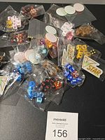 overview of sealed packets of dice, condition markers and VSTAR markers