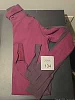 Folded bodysuit showing sleeves and body