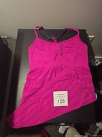 Front view of magenta Lululemon long tank showing ruched bust and adjustable straps