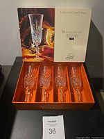 Open presentation box with four crystal champagne flutes