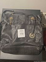 Full view of black leather Michael Kors bag front and base