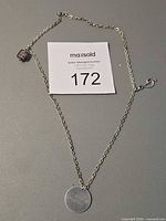 Full view of necklace showing chain, pendant, bead, and clasp
