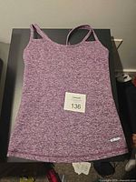 Front view of heather purple One Tooth racerback tank with logo patch visible