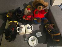 Full lot showing two plush mounties, two plush horses, two steins, shot glass, plate