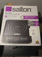 Front of box showing Salton portable induction cooktop and features