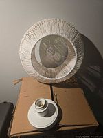 White rope-wrapped shade with socket base on box
