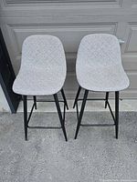 Front view of two matching upholstered bar stools