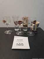 Six shot glasses displayed together on tabletop