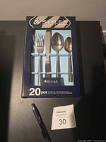 Front of sealed Stylex 20-piece cutlery set box showing utensils through window