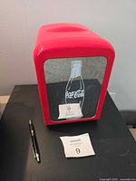 Front view of red Coca-Cola mini fridge with glass door