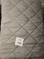 Folded grey weighted blanket showing diamond quilting