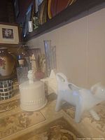 Group shot showing cow creamer, butter dish, vases, bottle and star