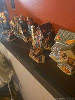 All miniature village pieces lined on shelf