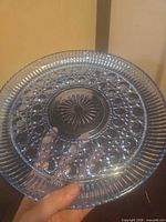 Front view of blue pressed glass platter showing hobnail pattern and ribbed edge