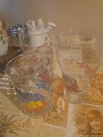 Three Coca-Cola Santa pint glasses grouped on table