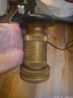 Side view of brass nozzle showing body markings and adjustable ring