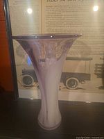 Full view of glass vase showing lavender and white swirl, flared rim