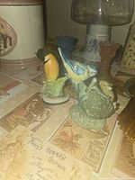 Both porcelain bird figurines on tabletop