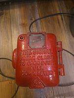 Front view showing entire fire alarm box with raised lettering and hinge