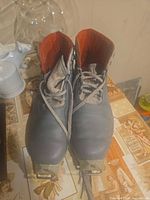 Top view of both Salomon SR301 boots showing lace-up design and orange interior