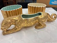 Front view showing leopard planter and two ribbed planters